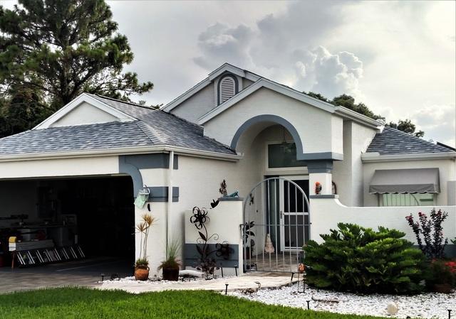 White brick home with gray accents and roof