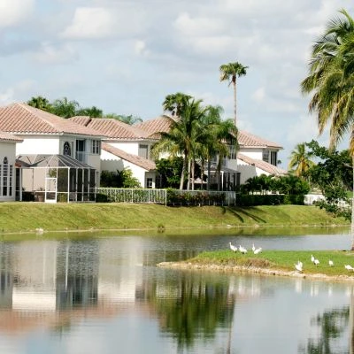 A house on the water with a new clay tile roof installed by Alan's Roofing.